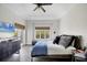 Bright bedroom features a large window, a ceiling fan, and access to a private balcony at 7142 Hawks Harbor Cir, Bradenton, FL 34207