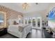 Cozy bedroom with flower wall, tile floors, and balcony access through glass doors at 7142 Hawks Harbor Cir, Bradenton, FL 34207