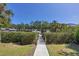 Picturesque dock with lush green hedges, showcasing a tranquil path to waterfront access and boating amenities at 7142 Hawks Harbor Cir, Bradenton, FL 34207
