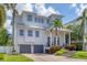 Beautifully designed two-story home with lush landscaping, featuring a welcoming front porch and a two-car garage at 7142 Hawks Harbor Cir, Bradenton, FL 34207