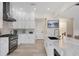 Bright kitchen with white cabinetry, stainless steel appliances, and large island with seating at 7142 Hawks Harbor Cir, Bradenton, FL 34207