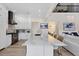 Bright kitchen with white cabinets, stainless steel appliances, and a large island with seating at 7142 Hawks Harbor Cir, Bradenton, FL 34207