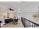 Bright loft area features a ceiling fan, table with chairs, and views of the lower level and outside at 7142 Hawks Harbor Cir, Bradenton, FL 34207