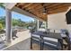 Inviting outdoor patio with comfortable seating, ceiling fan and a glimpse of the pool and well manicured landscaping at 7142 Hawks Harbor Cir, Bradenton, FL 34207