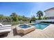 Beautiful backyard pool and spa with lush landscaping offering a serene and private oasis at 7142 Hawks Harbor Cir, Bradenton, FL 34207