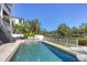 A sparkling swimming pool with patio and lush tropical foliage creating a private backyard retreat at 7142 Hawks Harbor Cir, Bradenton, FL 34207