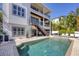 Expansive pool and patio area, featuring a multi-story home with balconies overlooking the backyard oasis at 7142 Hawks Harbor Cir, Bradenton, FL 34207