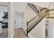 Elegant staircase with dark wood railing and treads, complemented by a modern chandelier at 7142 Hawks Harbor Cir, Bradenton, FL 34207