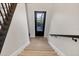 Staircase features a glass-paned door with hardwood flooring, offering a bright and stylish entrance at 7142 Hawks Harbor Cir, Bradenton, FL 34207
