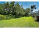 Green backyard with mature trees and lush plantings creates a peaceful view at 8711 51St E Ter, Bradenton, FL 34211