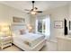Cozy bedroom with natural light from the window, a ceiling fan, and neutral decor at 8711 51St E Ter, Bradenton, FL 34211