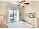 Bright bedroom featuring a ceiling fan, large window, and ample dresser storage at 8711 51St E Ter, Bradenton, FL 34211
