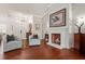 Elegant living area featuring hardwood floors, a fireplace, and a view of the entryway at 9422 Hawksmoor Ln, Sarasota, FL 34238