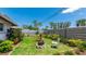 Landscaped backyard with a fire pit and seating area for outdoor relaxation at 959 Cumberland Rd, Venice, FL 34293