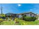 Spacious backyard with pool, patio, fire pit, and lush landscaping at 959 Cumberland Rd, Venice, FL 34293
