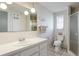 Clean bathroom with vanity, patterned wallpaper, and enclosed shower at 959 Cumberland Rd, Venice, FL 34293