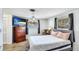 Cozy bedroom with wood floor, large dresser, television, and natural light at 959 Cumberland Rd, Venice, FL 34293