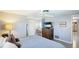 Comfortable bedroom features ceiling fan, wooden floors, and a built-in vanity desk at 959 Cumberland Rd, Venice, FL 34293