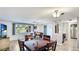 Bright dining room with wood flooring, a view of the front yard through a large window, and an open layout at 959 Cumberland Rd, Venice, FL 34293