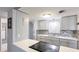 Contemporary kitchen with white countertops, gray cabinetry, stainless appliances, and tile backsplash at 959 Cumberland Rd, Venice, FL 34293
