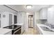 Modern kitchen featuring stainless steel appliances, white countertops, and a stylish tile backsplash at 959 Cumberland Rd, Venice, FL 34293