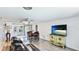 Cozy living room with wood flooring, a ceiling fan, and access to the outdoors through sliding glass doors at 959 Cumberland Rd, Venice, FL 34293
