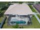 Aerial view of a home with a large screened-in pool area at 11458 30Th E Cv, Parrish, FL 34219