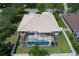 Aerial view of a home featuring a screened-in pool and well-manicured yard at 11458 30Th E Cv, Parrish, FL 34219
