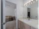 Light and airy bathroom featuring a vanity with a sink and a view into the bedroom at 11458 30Th E Cv, Parrish, FL 34219