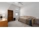 Bright bedroom featuring carpeted floors, a twin bed, and a built-in bookshelf at 11458 30Th E Cv, Parrish, FL 34219