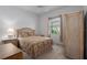 Bedroom with a wicker bed frame, a ceiling fan, and natural light from the window at 11458 30Th E Cv, Parrish, FL 34219