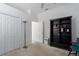 Bedroom featuring carpeted floors, built-in storage, and an adjacent bonus room at 11458 30Th E Cv, Parrish, FL 34219