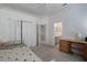 Neutral-toned bedroom featuring carpeted floors, a ceiling fan, and an attached bathroom at 11458 30Th E Cv, Parrish, FL 34219