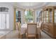 Formal dining area featuring large windows, elegant furniture, and a decorative chandelier at 11458 30Th E Cv, Parrish, FL 34219
