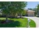Inviting single-story home featuring lush greenery, mature trees, and a well-maintained lawn at 11458 30Th E Cv, Parrish, FL 34219