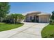 Charming home with a beautiful paver driveway and lush landscaping with palm trees at 11458 30Th E Cv, Parrish, FL 34219