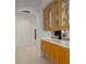 Hallway showcasing built-in glass display cabinets and seamless transition to the kitchen area at 11458 30Th E Cv, Parrish, FL 34219