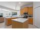 Well-appointed kitchen with stainless steel appliances, wood cabinets, and a large center island at 11458 30Th E Cv, Parrish, FL 34219