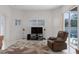 Comfortable living area features large windows, a TV, and sliding glass doors that lead to the pool at 11458 30Th E Cv, Parrish, FL 34219
