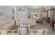 Bright and airy living room with neutral tones, large windows, and elegant furnishings at 11458 30Th E Cv, Parrish, FL 34219