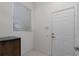 Clean, bright room with a window, white door, and beverage cooler at 11458 30Th E Cv, Parrish, FL 34219