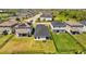 Overhead view of backyard and neighborhood, showcasing well-maintained lawns, fences and nearby community at 11571 Little River Way, Parrish, FL 34219