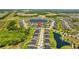 Aerial shot pinpointing the property's location in a community surrounded by ponds and green spaces at 11571 Little River Way, Parrish, FL 34219