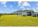 Spacious backyard featuring a well-maintained lawn, black fence and covered patio, ideal for outdoor activities at 11571 Little River Way, Parrish, FL 34219