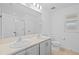 Bright bathroom features double sinks, quartz countertops, and a shower with glass doors at 11571 Little River Way, Parrish, FL 34219