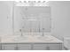 Bright bathroom featuring double sinks, a large mirror, and neutral decor at 11571 Little River Way, Parrish, FL 34219