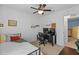 Bedroom with a desk setup, overhead fan, and a glimpse into another room at 11571 Little River Way, Parrish, FL 34219