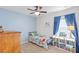 Bright bedroom with blue accent wall and decorative bookshelves at 11571 Little River Way, Parrish, FL 34219