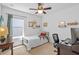 Bedroom featuring desk, dark ceiling fan, and natural light at 11571 Little River Way, Parrish, FL 34219