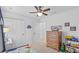 Bedroom with wooden dresser, toy collection, and dinosaur decor at 11571 Little River Way, Parrish, FL 34219